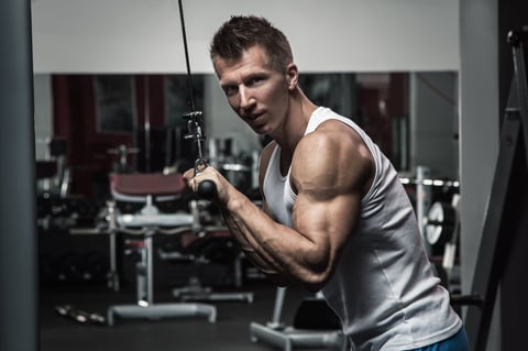 Muscular man during workout in the gym