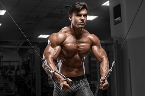 Muscular man workout in gym doing exercises for chest, cable crossover