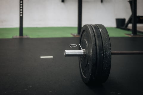 Barbell loaded with weight plates on the gym floor