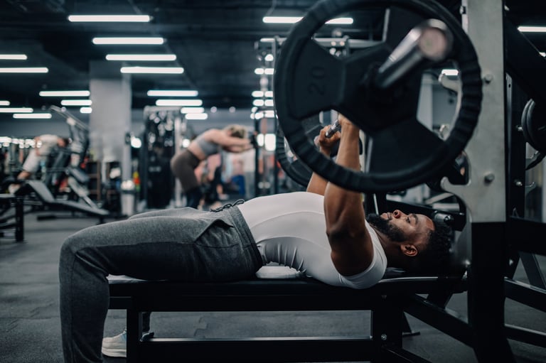 Young athlete performs a bench press exercise