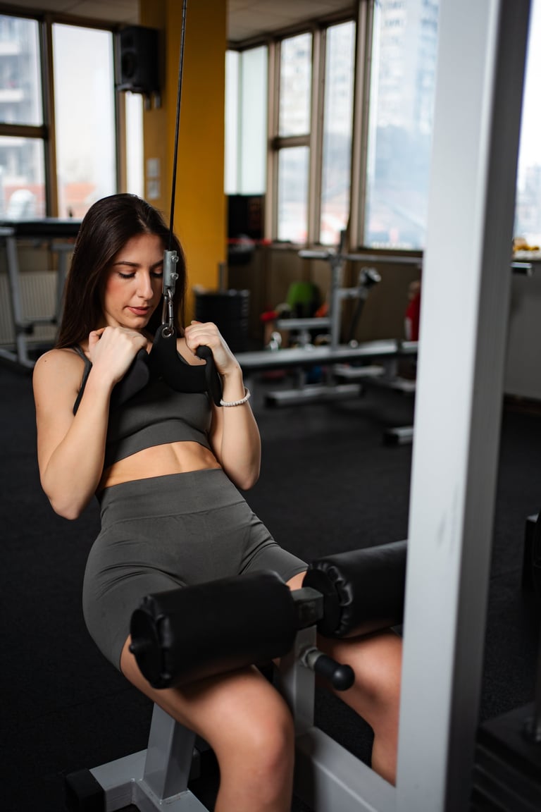 Determined young woman performing strength training exercise at the gym