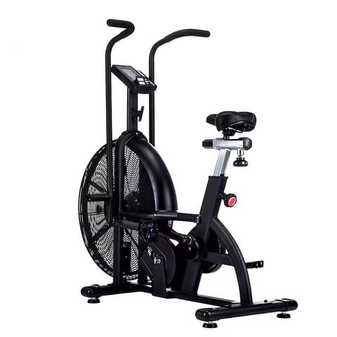 Black stationary exercise bike with large fan wheel and upright frame on white background