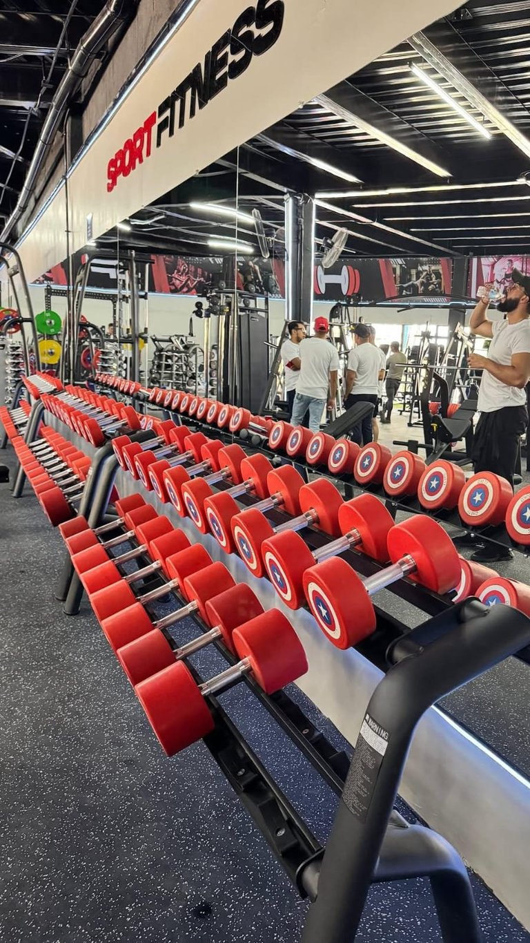 Interior of a Sport Fitness gym with rows of red dumbbells