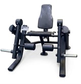 Black and gray leg press machine with padded backrest and foot platforms isolated on white background