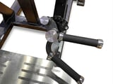 Close-up of knife sharpening tool with grinding wheels and metal blade