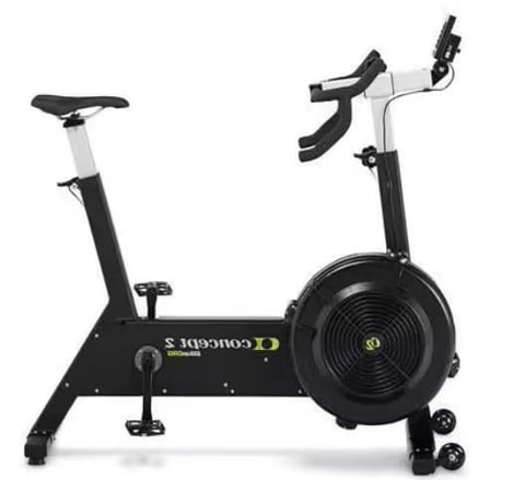 Black and white stationary exercise bike with curved handlebars and large fan wheel